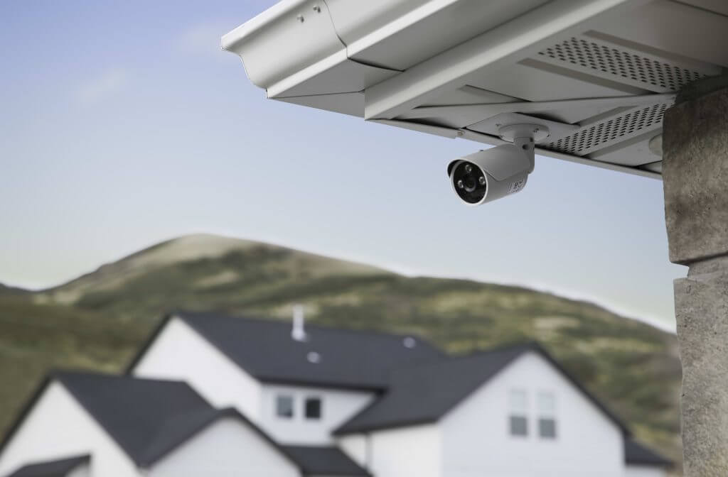 Surveillance camera mounted beneath an outdoor eave